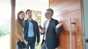 Real estate agent showing couple around new home