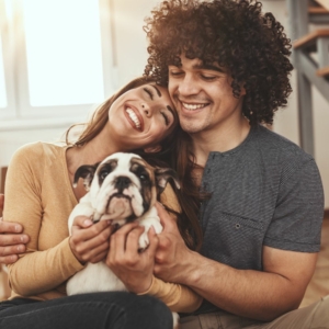 Happy couple holding new puppy